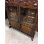 A oak smokers cabinet fitted with four drawers