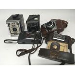 A collection of cameras including box camera Conway Agfa and others.
