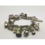 A silver charm bracelet and fifteen charms.