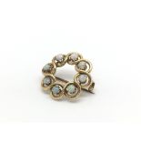 A 15ct gold brooch set with 8 opals. Weight approx