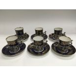 A set of six silver cup holders with six cups and
