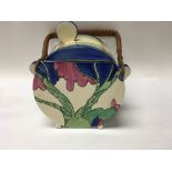 A Clarice cliff biscuit barrel decorated in the Ru