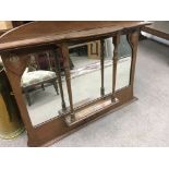 A oak over mantle mirror with art nouveau influenc