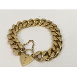 A gold plated link bracelet with heart padlock cla