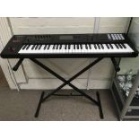 A Roland FA06 keyboard with stand, flight case, tw