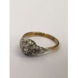 An 18ct gold and platinum ring set with diamond cl
