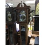 A modern grandmother clock with silvered rotating dial of ships etc, approx height 190cm.