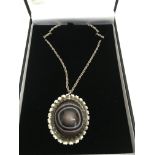 A silver and banded agate pendant necklace