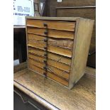 A small 8 drawer chest containing lead printing se