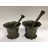 Two bronzed pestle and mortars.