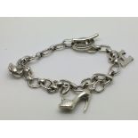A silver Links of London bracelet with three charm