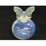 A Sabino glass perfume bottle with a butterfly sto
