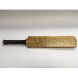 A small cricket bat, signed by the 1965 England, N