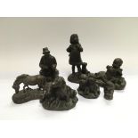 Seven bronzed figures comprising mainly children a
