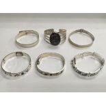 Six silver bangles, various styles.