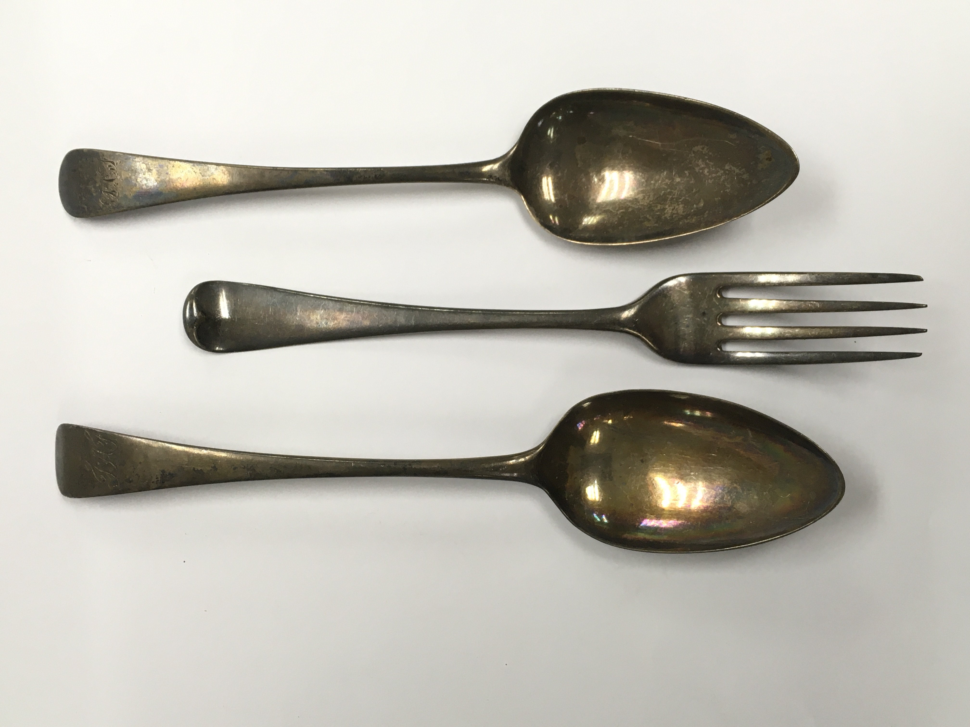 A Georgian silver fork and two Georgian silver spo