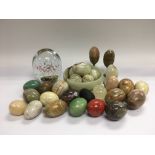 A glass paperweight and a collection of polished m