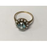 A 9 ct gold ring inset with seed pearl and aquamar