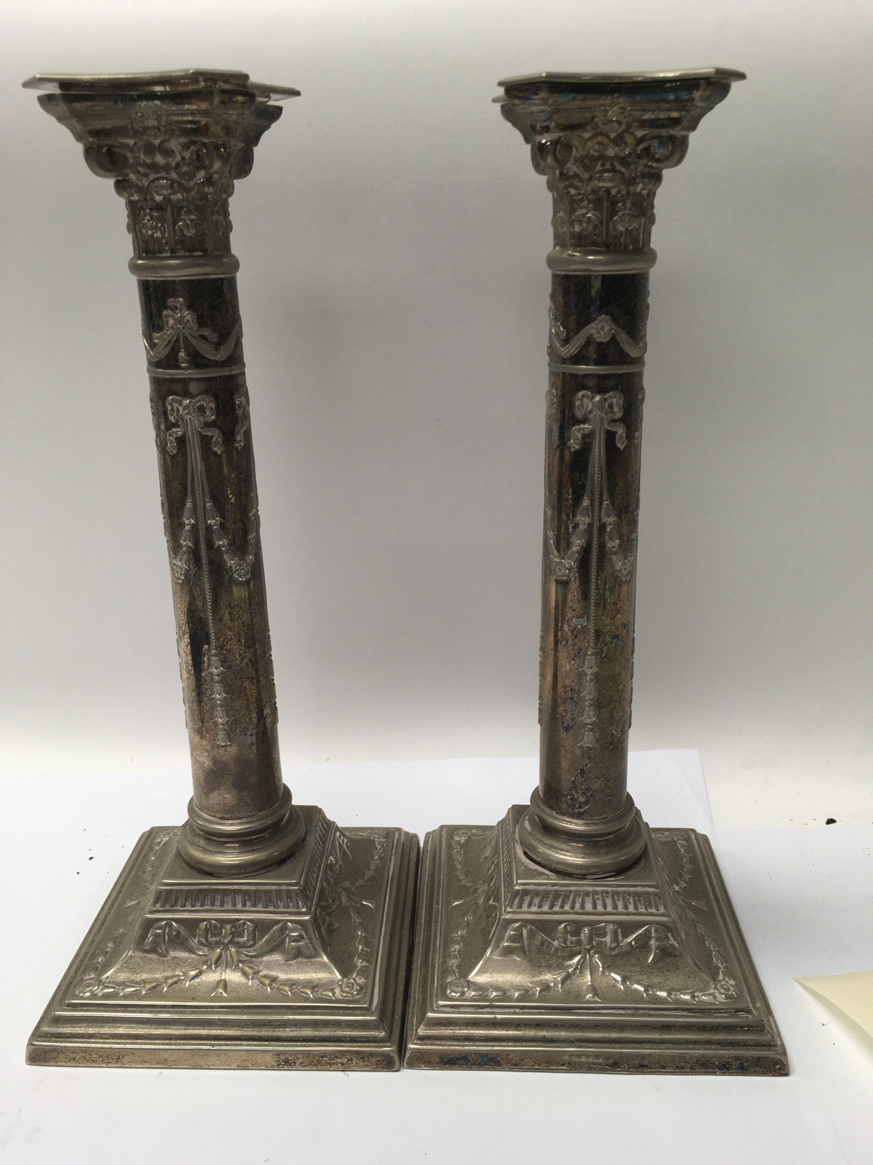 A pair of Edwardian silverplated candle sticks 30 cm