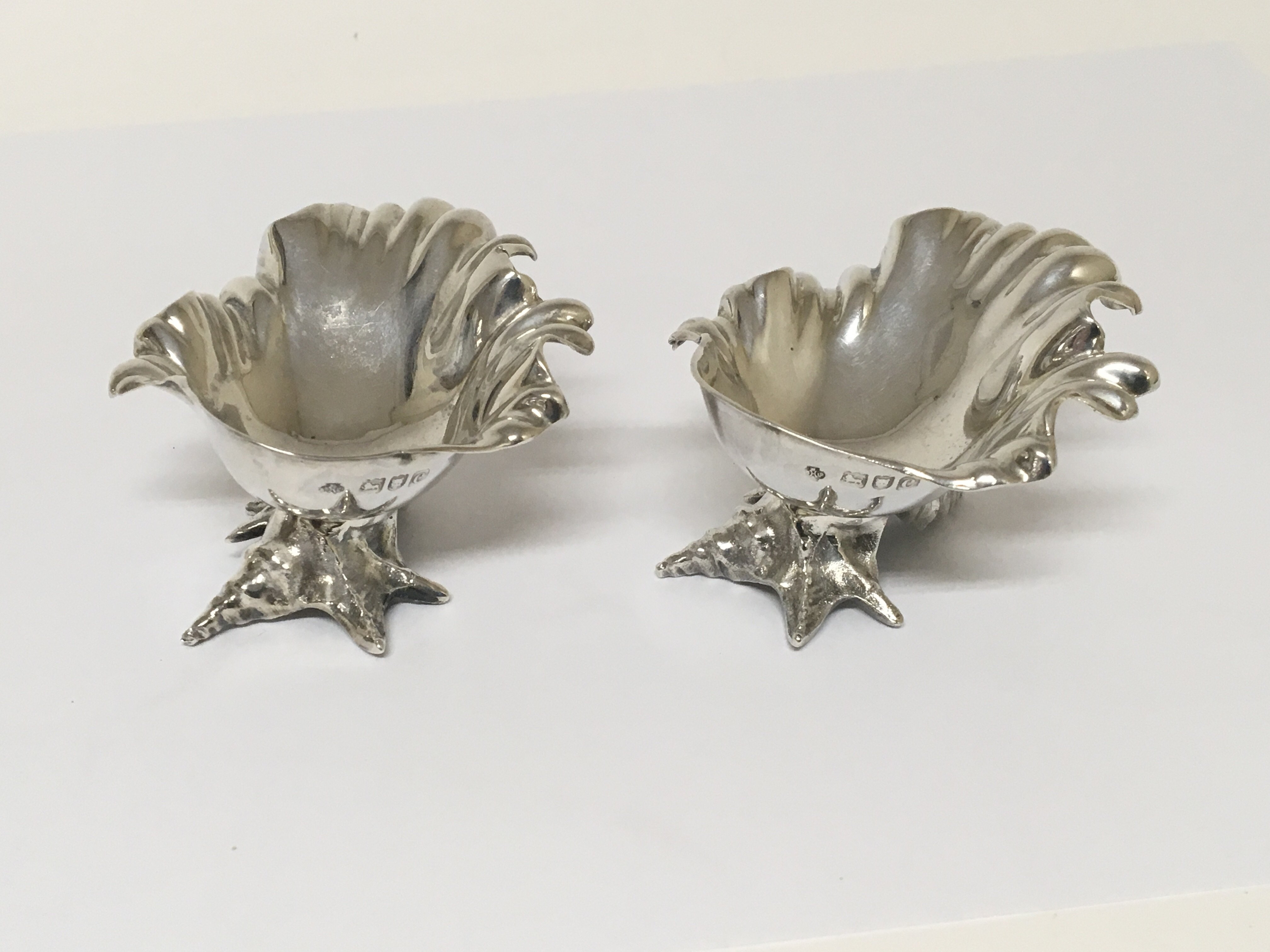 A pair of Rococo influence shell shapes silver sal