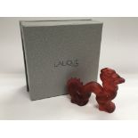 A boxed Lalique ornament of a red dragon, approx l