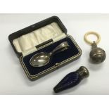 A silver baby's rattle, cased silver spoon and a s