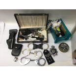 A box containing a collection of police items, inc