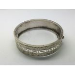 A silver bangle in Greek key pattern, Chester hall