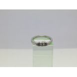 An 18ct white gold three stone diamond ring, appro