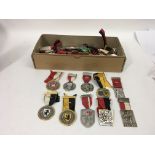 A box containing a collection of Swiss medals, app