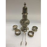 A silver sugar caster, four silver napkin rings an