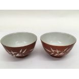 A pair of Chinese iron ground tea bowls with bambo
