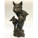 A bronze figural group of a wolf and cubs, signed