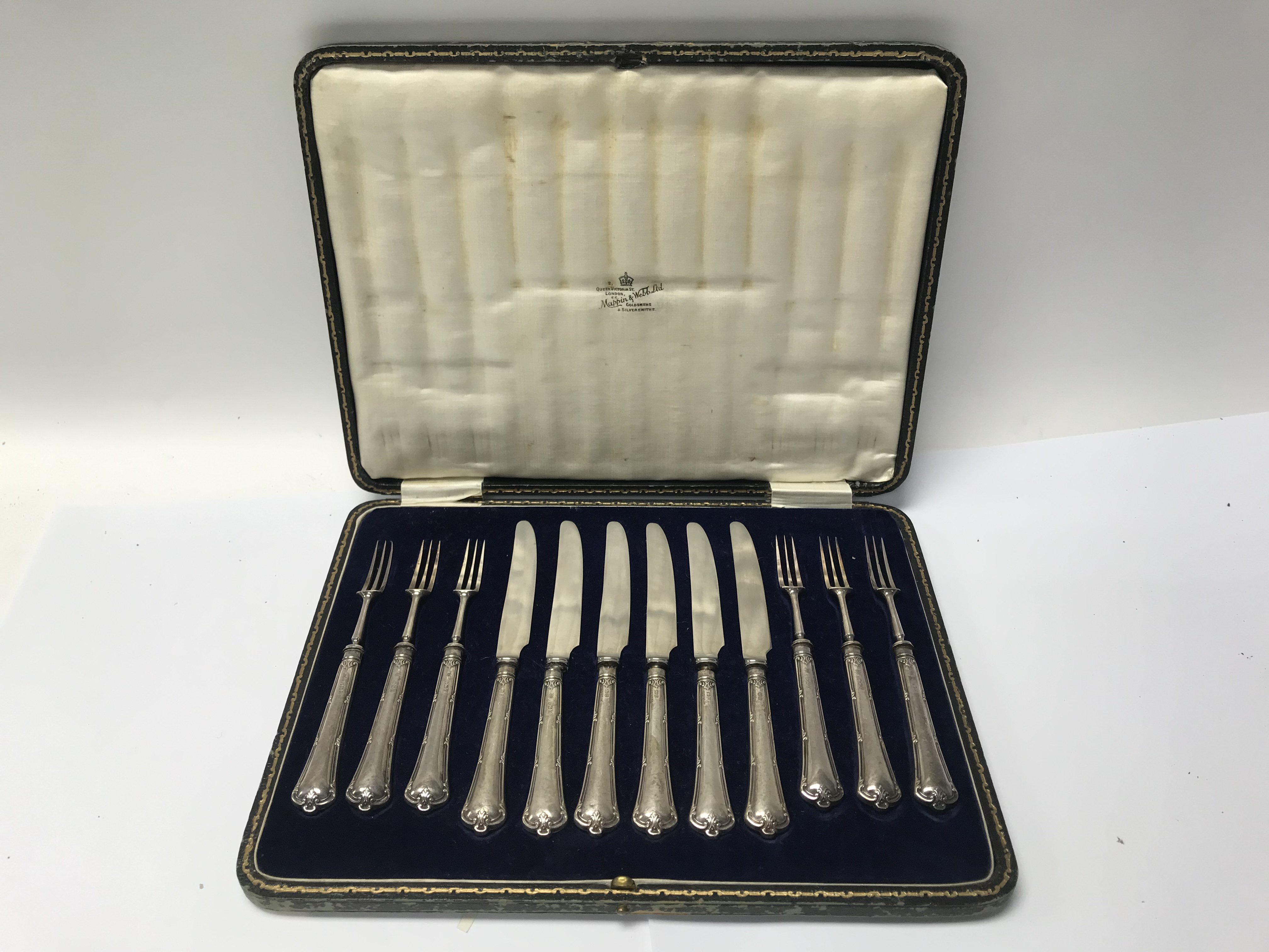 A cased set of silver handled knives and forks.