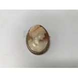 A 9ct gold cameo brooch with a small chain. Weight