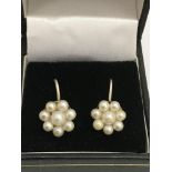 A pair of silver and pearl screwback earrings