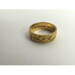 A 22ct engraved gold wedding band ring.Approx 7.8g