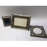 A group of three silver hallmarked photo frames.