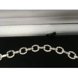 A 18 ct white gold link bracelet inset with baguette and round brilliant cut diamonds approx diamond