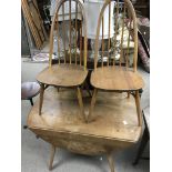 A ercol table with twin flap top with two stick ba