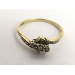 An 18ct gold ring set with three small diamonds.Ap