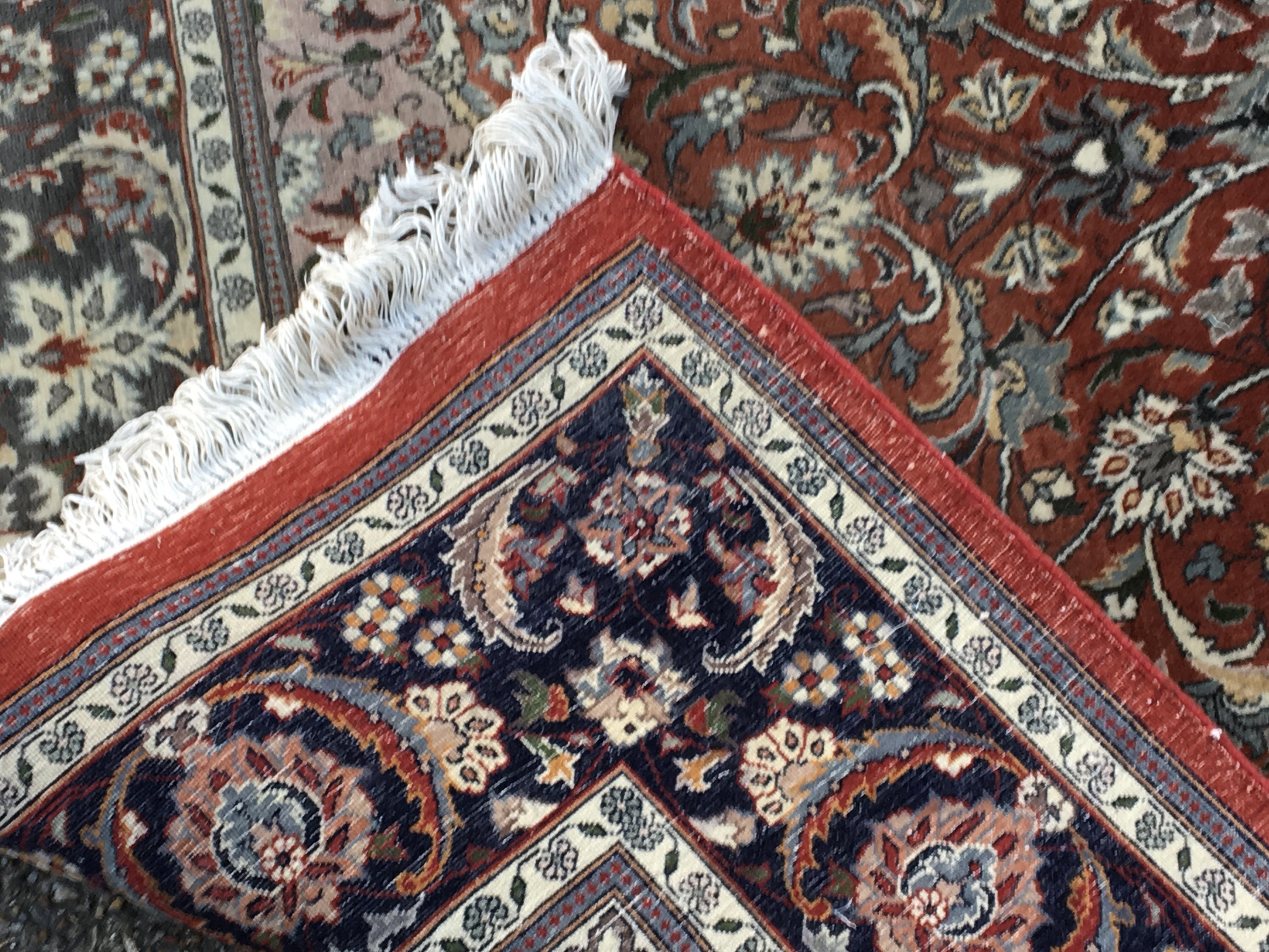 A hand knotted Persian rug with a large red centra - Image 3 of 3