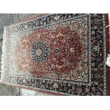 A hand knotted Persian rug with a large red centra