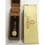 A boxed Omega gold ladies watch.