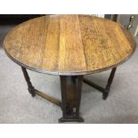 A small oak swivel top table