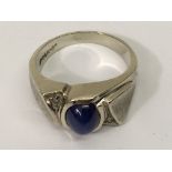 An modern design, white gold ring set with a blue
