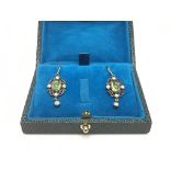 A pair of yellow metal set with opals and peridot,