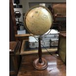 A modern globe on a turned wood base with internal light.