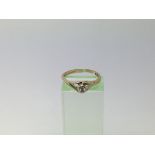 A 9ct gold ring set with a small solitaire diamond