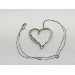 An 18ct white gold heart shaped pendant on a chain